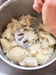 Drain and mash potatoes to let some of the steam out