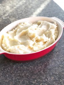 In a casserole dish, put potatoes in a warm oven to keep hot.