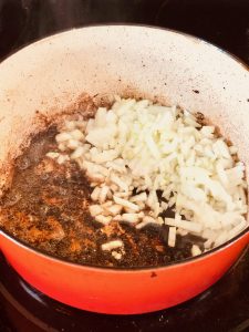 Reduce heat and add onions & garlic