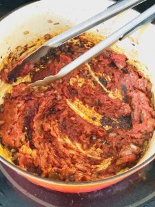 Cook tomato sauce until its a dark rusty red