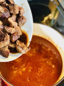 Then pour the browned meat, and all those lovely juices, back into the stew pot