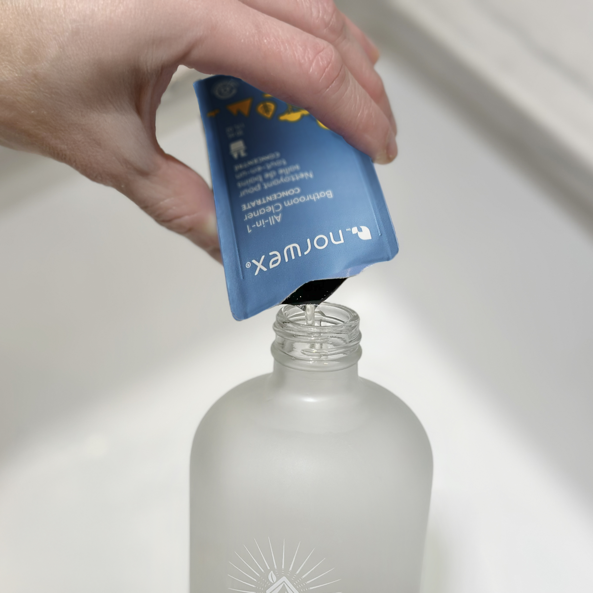 Pour a packet of the Norwex All-in-1 Bathroom Cleaner into a Norwex Forever Bottle, and fill with water

